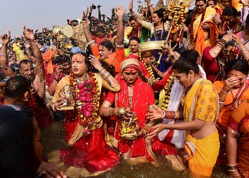 Transgender rights activist and Kinnar Akhada chief Achraya Mahamandaleshwar Laxmi Narayan Tripathi and other memebers takes a holy dip at Sangam on the auspicious ‘Mauni Amavasya’ day during the Kumbh Mela. PTI Photo