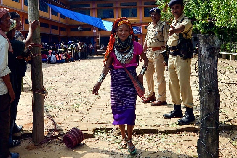 An Indian Reang tribal woman voter leaves a polling station after casting her vote during India’s general election at Kanhmun village, near Tripura border on April 11, 2019. – India’s mammoth six-week general election kicked off April 11, with polling stations in the country’s northeast among the first to open. (Photo by STR / AFP)