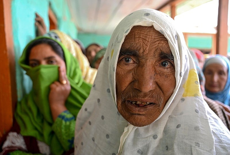 Indian Kashmiri 100-year-old, Sarwa Bano, looks on before casting her vote at a polling station during the first phase of India’s general election at Kandi Kupwara in Handwara district, north of Srinagar, on April 11, 2019. – India’s mammoth six-week general election kicked off April 11, with polling stations in the country’s northeast among the first to open. (Photo by Tauseef MUSTAFA / AFP)