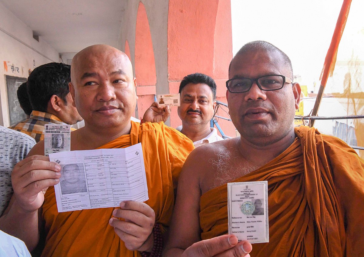 Bodh Gaya: Buddhist monks show their voter identity cards before casting their votes during the first phase of the general elections, at a polling station in Bodh Gaya, Thursday, April 11, 2019. (PTI Photo)(PTI4_11_2019_000043B)