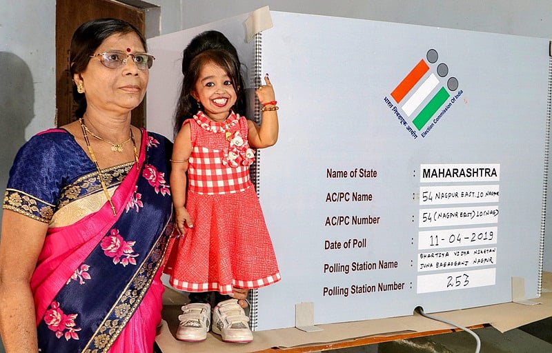 Nagpur: World’s shortest woman Jyoti Amge (25), shows her finger marked with indelible ink after casting vote during the first phase of general elections, at a polling station in Nagpur, Thursday, April 11, 2019. (PTI Photo)(PTI4_11_2019_000116B)