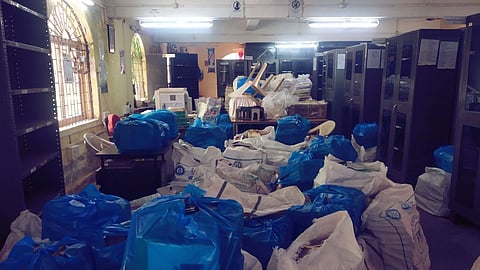 Piles of books stacked up in Plastic bags 