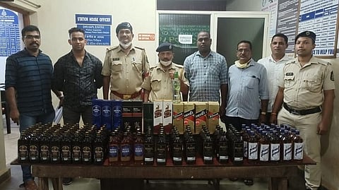 Konkan Railway Police with the seized liquor worth Rs&nbsp;25,100&nbsp;