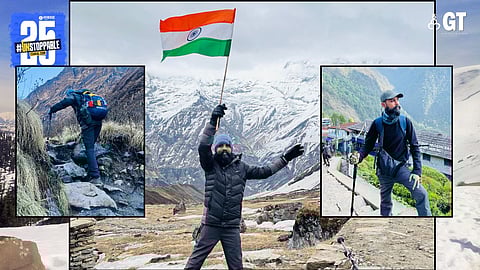 Ritesh Vaigankar holds the national flag at Annapurna base camp.