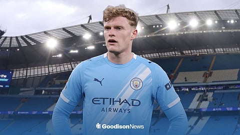 Jarrad Branthwaite in a Man City top, with the Etihad Stadium behind him