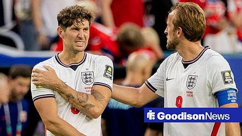 John Stones holding his shoulder for England
