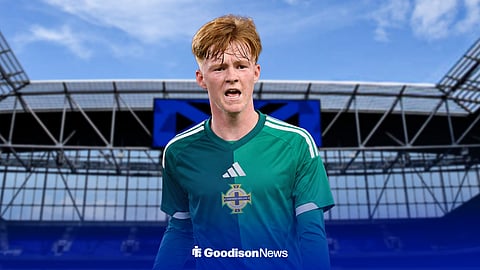 Everton's Braiden Graham wearing a Northern Ireland shirt with Hill Dickinson Stadium in the background