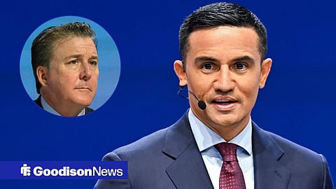 Everton owner Dan Friedkin and Tim Cahill speaking into a microphone