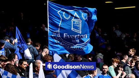 Everton fans holding up a flag
