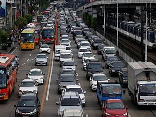 Motorists drive through a heavy traffic flow near a passing metro train along the main highway EDSA in Makati, Metro Manila, Philippines June 21, 2016. 