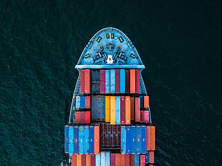 A top view of a container ship. There is substantial evidence that import competition — particularly from China — imposed significant costs on some American communities. Economists David Autor, David Dorn and Gordon Hanson found that rising Chinese import competition from 1990 to 2007 increased unemployment, reduced labour-force participation and lowered wages in exposed US labour markets.