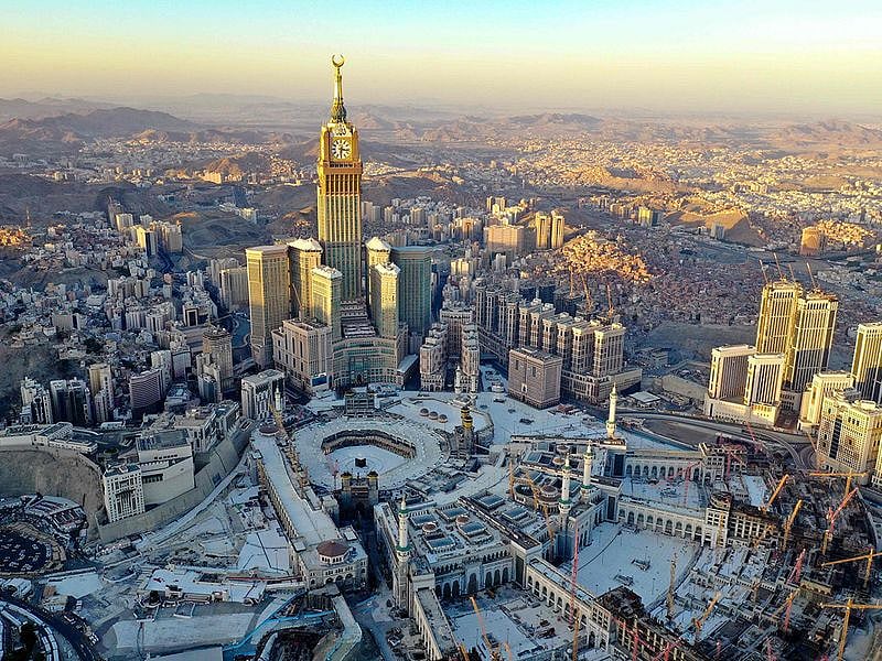 Above, an aerial view shows the Grand Mosque and the Mecca Tower in a deserted surrounding on the first day of the Muslim fasting month of Ramadan, in the Saudi holy city of Mecca.