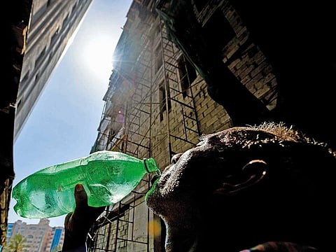 Staying hydrated: Worker at a construction site at Al Majaz in Sharjah in 2024. 