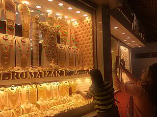 Shoppers browse gold jewellery at Dubai’s Gold Souk as prices jump following a global rally.