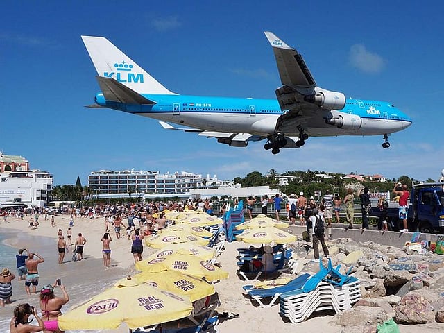 The beach at Maho Bay is one of the world's premier planespotting destinations. Aeroplanes landing at the Princess Juliana Airport, St. Maarten , fly over beachgoers. Maho public beach is located at the end of this runway which results in huge gusts of wind and sand for sunbathers but also offering up a perfect picture. The runway is 2,164 metre long, and planes must approach over the water at an extremely low altitude appearing to be just feet above the heads of the public.
