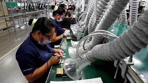 Filipinos work at the assembly line of Taiwan-based Kinpo Electronics' factory in Malvar, Philippines.