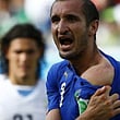 Italy's Giorgio Chiellini shows his shoulder after an apparent bite by Uruguay's Luis Suarez.