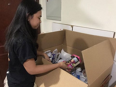 A Filipino expat packs a balikbayan box for her loved ones back home. Photo for illustrative purposes only