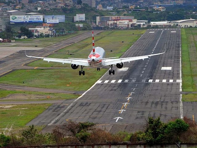 Toncontin International Airport in Tegucigalpa, Honduras. The Toncontín airport runway is 2,163m long and was built at an elevation of 1,005m. Due to its location next to the mountains and its narrow size, landing is very complicated. Pilots must make a dramatic sharp turn and land near the valley.