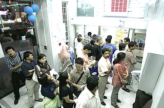 Customers form a queue at a money remittance centre in Dubai 