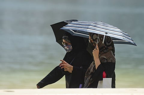 The highest temperature recorded in the country today was 49.8°C in Al Jazeera BG, Al Dhafra region, at 2:45pm. Above, women walk with umbrellas during the hot weather in Sharjah.