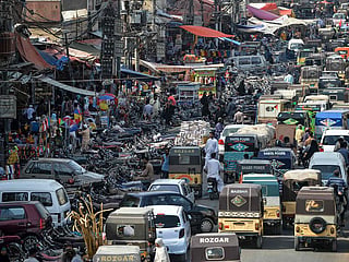 Motorists make their way in a traffic jam alongside a market in the Pakistan's port city of Karachi. File photo