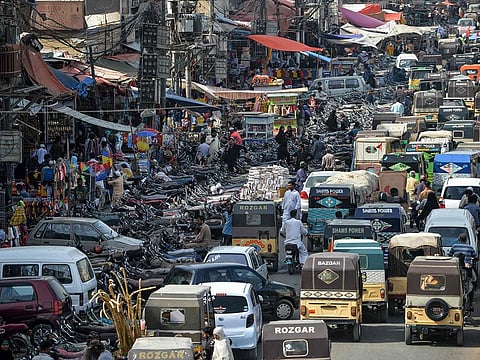 Motorists make their way in a traffic jam alongside a market in the Pakistan's port city of Karachi. File photo