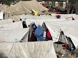 Internally displaced Afghan take refuge in a public park Kabul. Tens of thousands of Afghans have fled their homes, with many fearing a return to the Taliban's oppressive rule. The group had previously governed Afghanistan under a harsh version of Islamic law in which women were largely confined to the home.