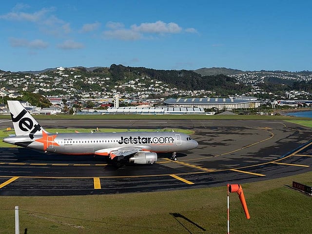 Jetstar aeroplane at Wellington airport, New Zealand. This airport features a one-lane 1,935-metre runway that appears to start and end in the water.