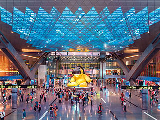 Passengers at Doha International Airport. While airfares remain elevated on many routes this summer, travellers can still find return flights from the UAE to destinations including Muscat, Istanbul, Cairo and Athens for under Dh2,000 by choosing the right routes and travel dates.