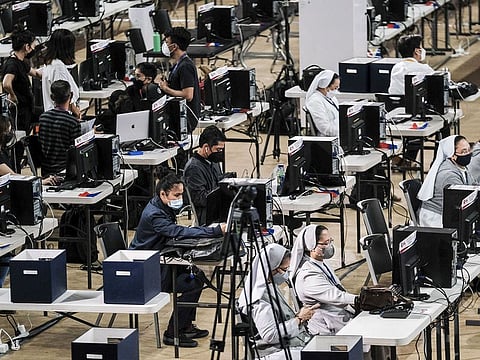 File photo: Volunteers at election watchdog Parish Pastoral Council for Responsible Voting's (PPCRV) center for conducting an independent vote count for the presidential election in Manila, the Philippines, on Monday, May 9, 2022. Polling centers in the Philippines have begun to close and vote counting is underway for a presidential race.