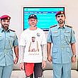  The European tourist with Sharjah Police officials.