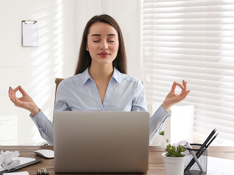 Woman meditating in office