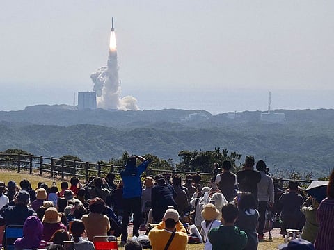 Visitors watch the launch of the "H3" rocket, a Japan's next generation rocket carrying the advanced optical satellite "Daichi 3", at the Tanegashima Space Center in Kagoshima, southwestern Japan on March 7, 2023.