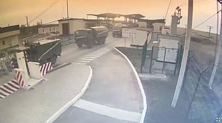 Video screengrab shows military vehicles crossing into Ukraine's Kherson Oblast from Crimea through the Kalanchak border control point, after Russian President Vladimir Putin authorized a military operation in eastern Ukraine. Screenshot taken from a file video uploaded Feburary 24, 2022 by the State Border Guard Service of Ukraine.
