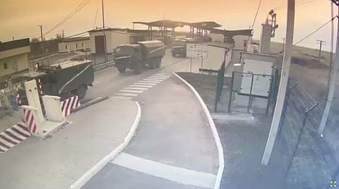 Video screengrab shows military vehicles crossing into Ukraine's Kherson Oblast from Crimea through the Kalanchak border control point, after Russian President Vladimir Putin authorized a military operation in eastern Ukraine. Screenshot taken from a file video uploaded Feburary 24, 2022 by the State Border Guard Service of Ukraine.