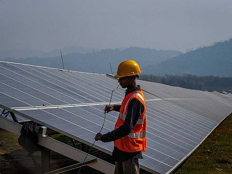 Photo shows a man works at a solar power plant in Mikir Bamuni village, Nagaon district, northeastern Assam state, India, Feb. 18, 2022.