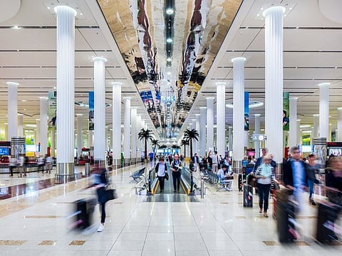 
Passengers at Dubai International Airport as UAE residents prepare for summer travel amid higher airfares and changing holiday preferences.