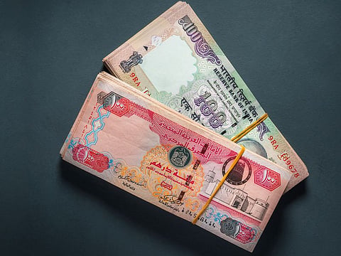 Currency traders monitor market movements as the Indian rupee slipped to a record low against the US dollar during Friday trading.