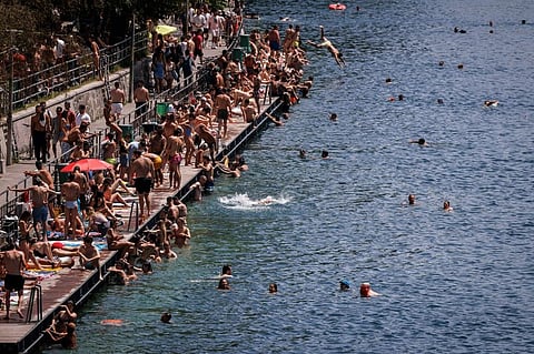 People swim in the river Limmat at Letten, in Zurichin this file photo taken on June 18, 2022.