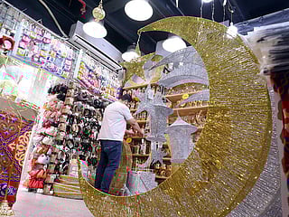  A vendor arranges decorative items in his shop at a market in Kuwait City on March 10, 2024, ahead of Ramadan.