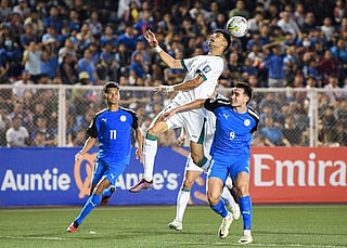 Iraq's Zaid Tahseen Hantoosh heads the ball against Jens Sebastian Rasmussen and Javier Gayoso of the Philippines during the 2026 Fifa World Cup AFC qualifiers football match at the Rizal Memorial Stadium in Manila on Tuesday.