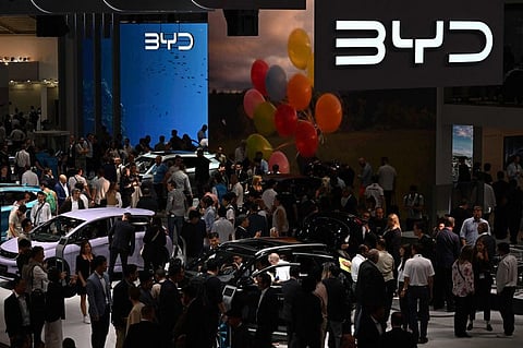 Visitors are pictured at the booth of Chinese car maker BYD presented at the International Motor Show (IAA) at the fairgrounds in Munich, southern Germany, on September 5, 2023. Germany's IAA MOBILITY auto show, one of the world's largest, will be open for the public from September 5 to 10, 2023 and showcase all car-related topics.  