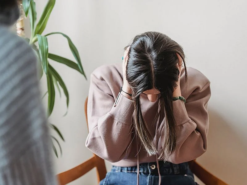 Woman with head down