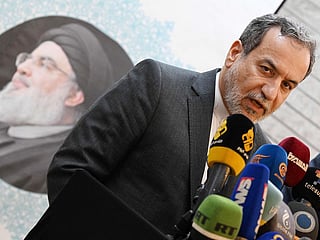 Iranian Foreign Minister Abbas Araghchi speaks to the press, in front of the portrait of slain Lebanese Hezbollah leader Hassan Nasrallah, after meeting with Syrian officials at the Iranian embassy in Damascus on October 5, 2024. 