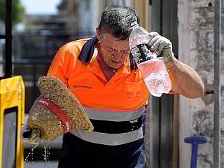 The culprit is a high-pressure anticyclone dubbed Cerberus — the multi-headed dog that guards gates to the underworld in Greek mythology. The third heat wave in a month was expected to affect much of the Mediterranean and last until Wednesday. Above: A worker cools off while working in a street during a heatwave in Sevilla, in the southern Spanish region of Andalusia. 