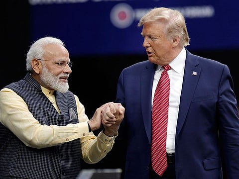 Prime Minister Narendra Modi and President Donald Trump shake hands in Houston in 2019.