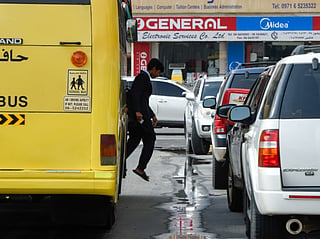 Students walk out of the school bus during the afternoon hours in Sharjah.  