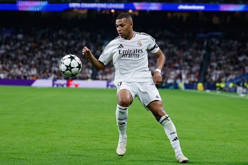 Kylian Mbappe controls the ball during a match against AC Milan.
