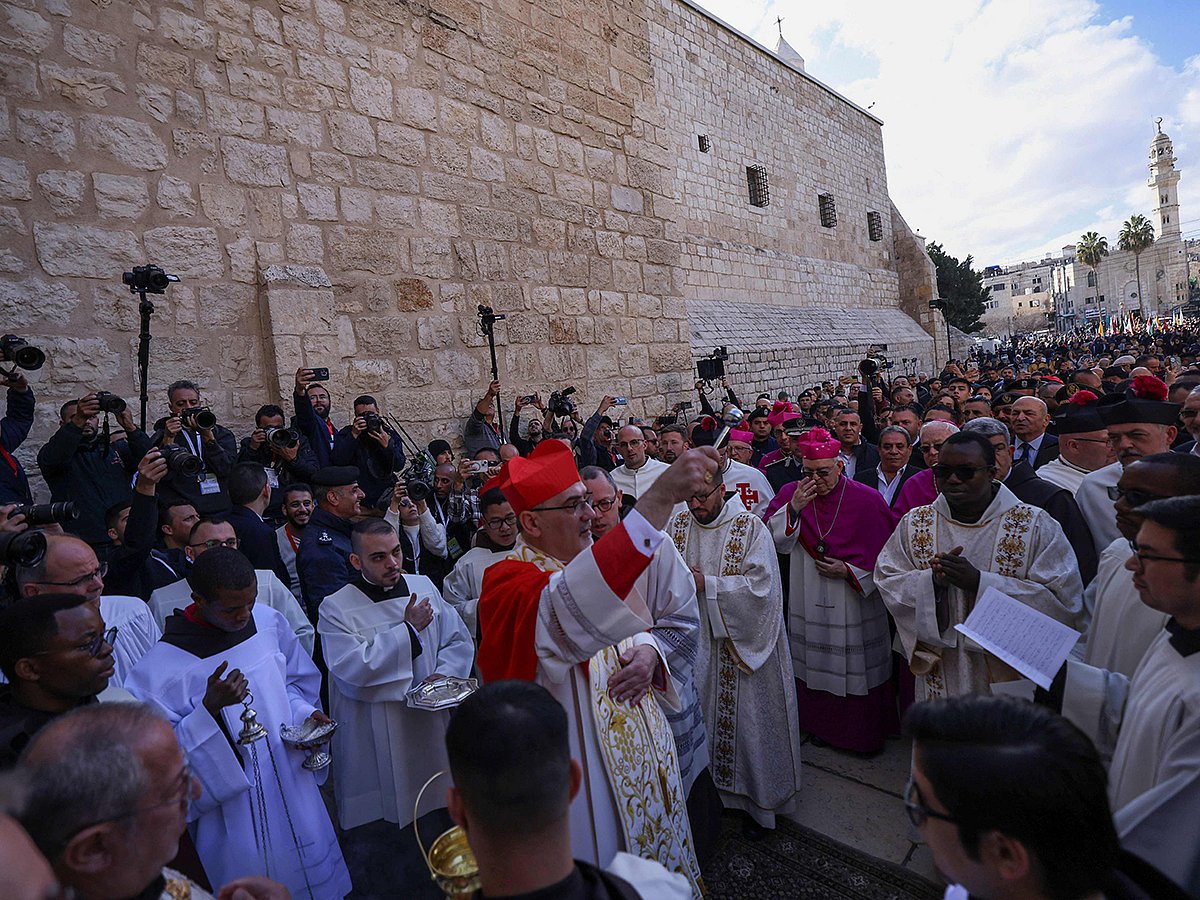 Latin Patriarch of Jerusalem Pierbattista Pizzaballa (C) leads the yearly Christmas procession outside the Church of the Nativity in Bethlehem town in the Israel-occupied West Bank on December 24, 2024.